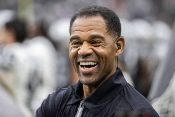 Former Raider player Eric Allen shares a laugh with staff on the sideline during a special trai ...