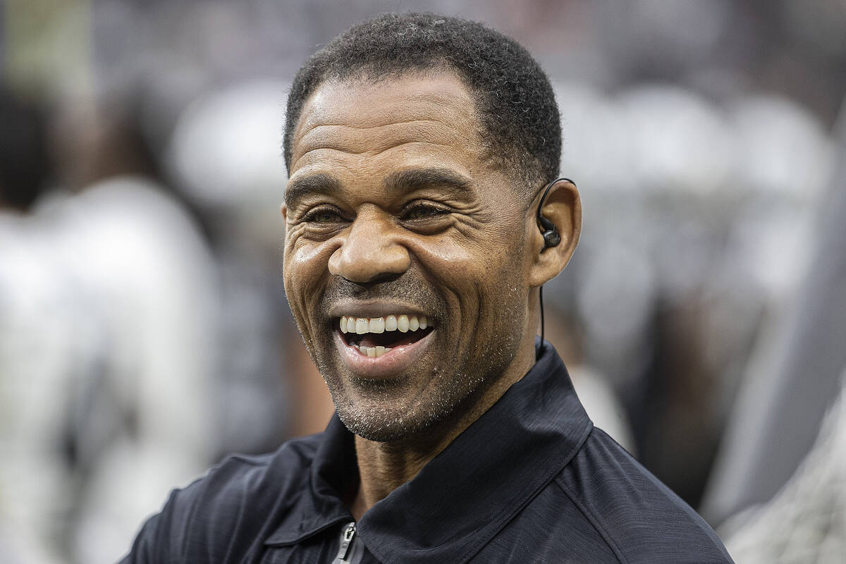 Former Raider player Eric Allen shares a laugh with staff on the sideline during a special trai ...