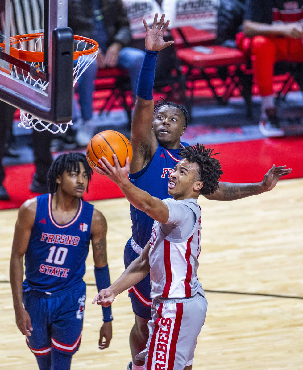 UNLV guard Dedan Thomas Jr. (11) gets inside of Fresno State Bulldogs guard Jalen Weaver (5) fo ...