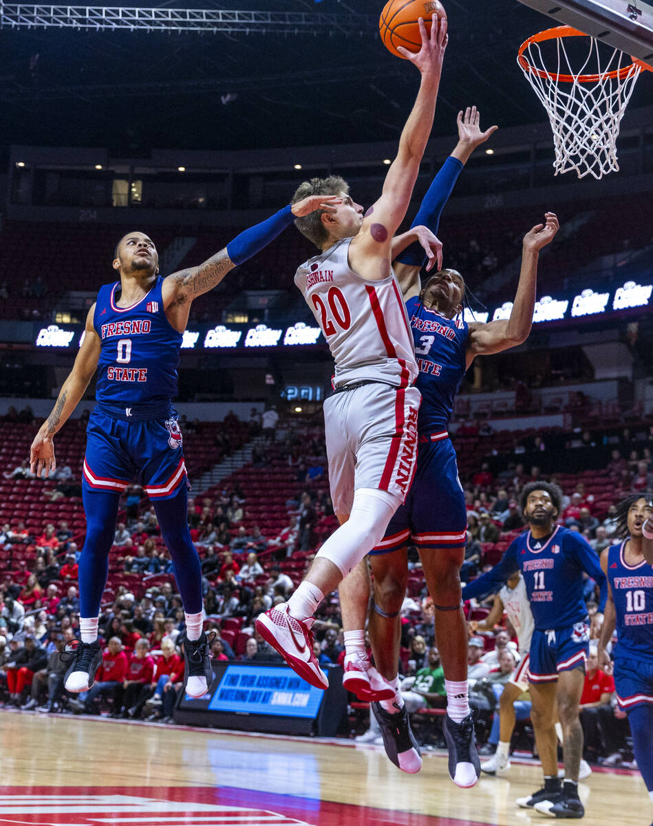 UNLV guard Julian Rishwain (20) lays in the ball over Fresno State Bulldogs forward Elijah Pric ...