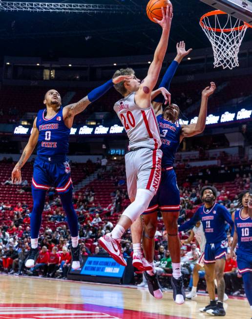 UNLV guard Julian Rishwain (20) lays in the ball over Fresno State Bulldogs forward Elijah Pric ...