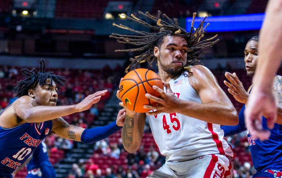 UNLV forward Jeremiah Cherry (45) looks for a shot against Fresno State Bulldogs forward Elijah ...