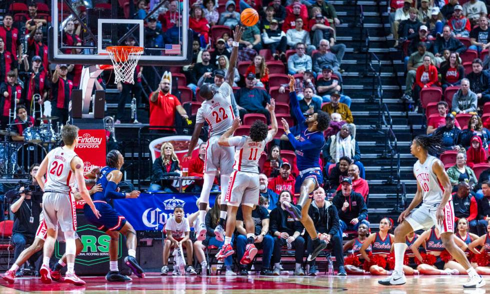 UNLV forward Pape N'Diaye (22) gets up above the rim to reject a shot by Fresno State Bulldogs ...