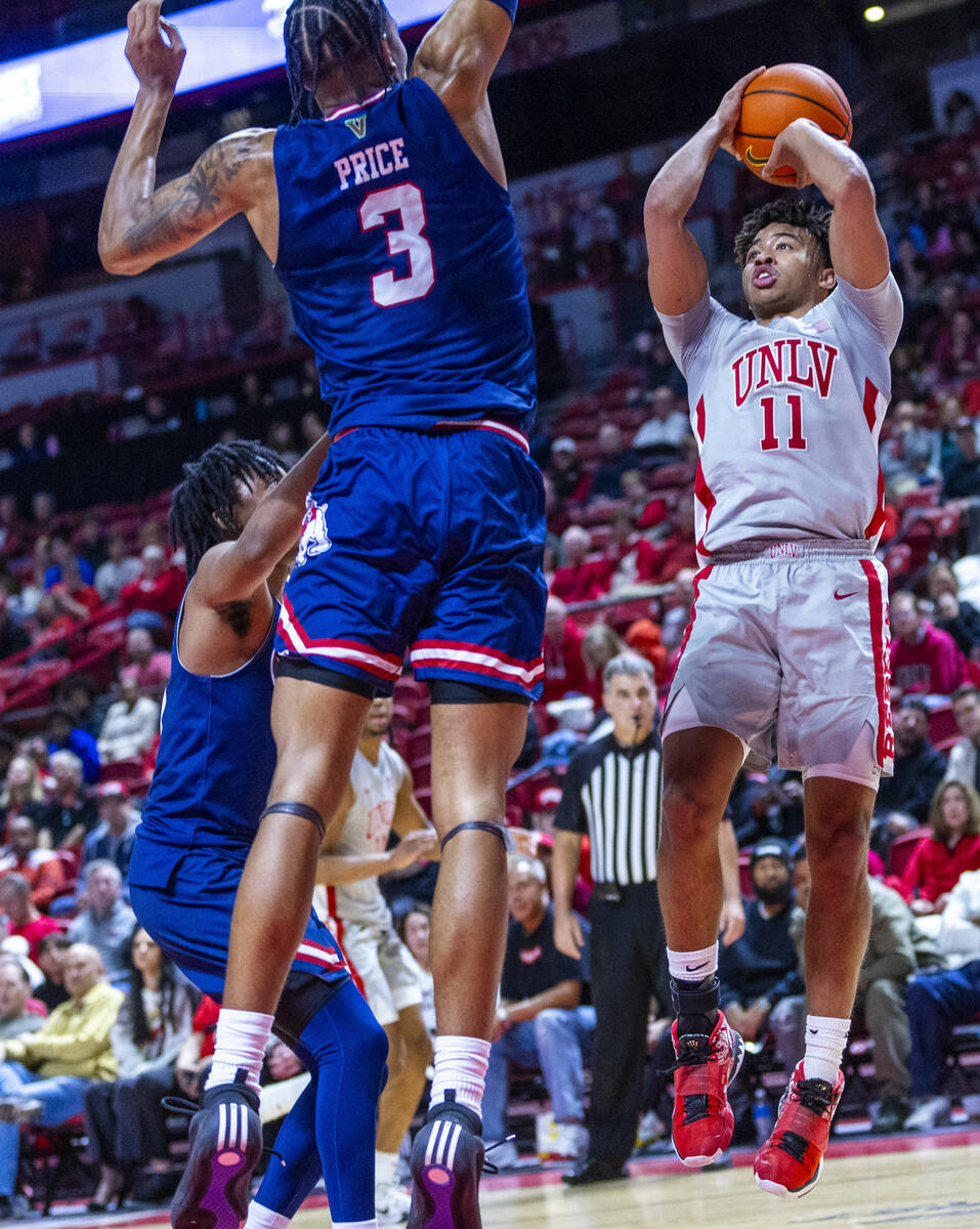 UNLV guard Dedan Thomas Jr. (11) looks to shoot against Fresno State Bulldogs forward Elijah Pr ...