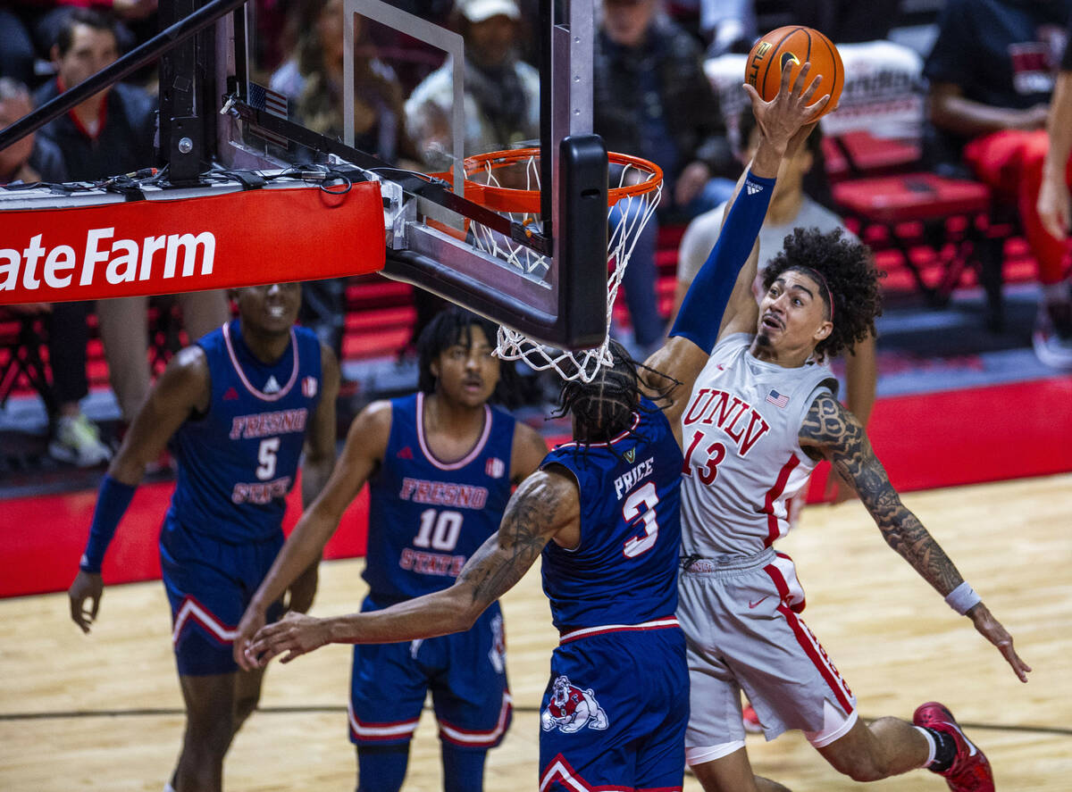 UNLV guard Brooklyn Hicks (13) looks to score against Fresno State Bulldogs forward Elijah Pric ...