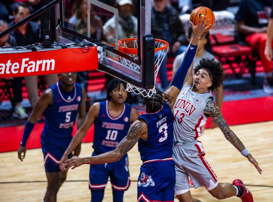 UNLV guard Brooklyn Hicks (13) looks to score against Fresno State Bulldogs forward Elijah Pric ...