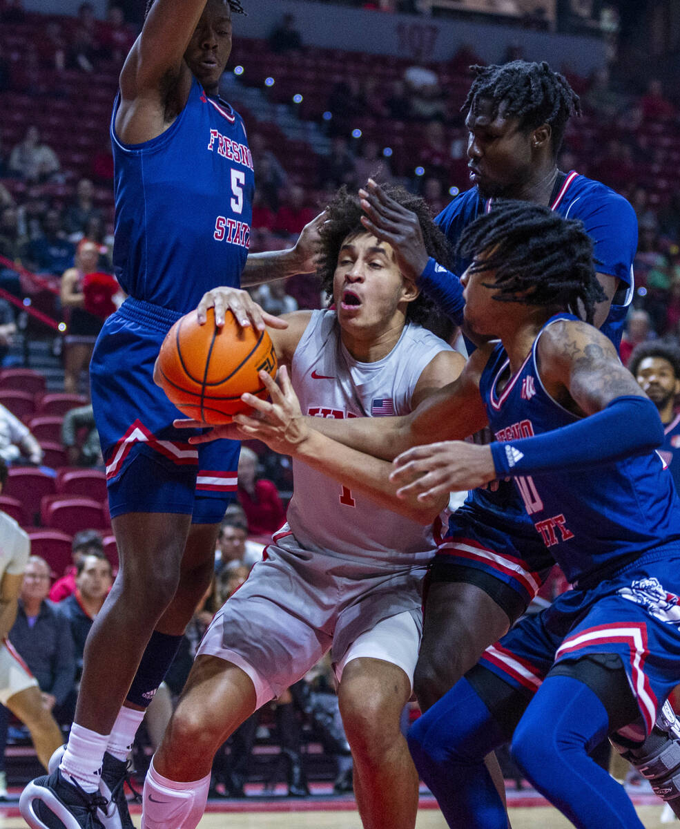 UNLV forward Jalen Hill (1) is ganged up on by Fresno State Bulldogs guard Jalen Weaver (5), fo ...