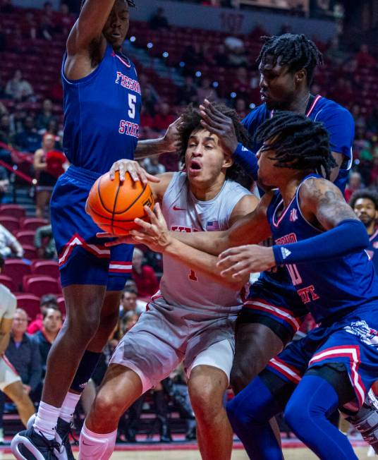 UNLV forward Jalen Hill (1) is ganged up on by Fresno State Bulldogs guard Jalen Weaver (5), fo ...