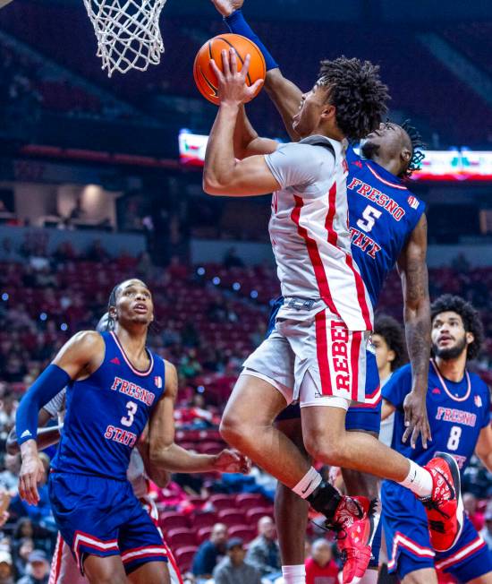 UNLV guard Dedan Thomas Jr. (11) gets inside of Fresno State Bulldogs guard Jalen Weaver (5) fo ...