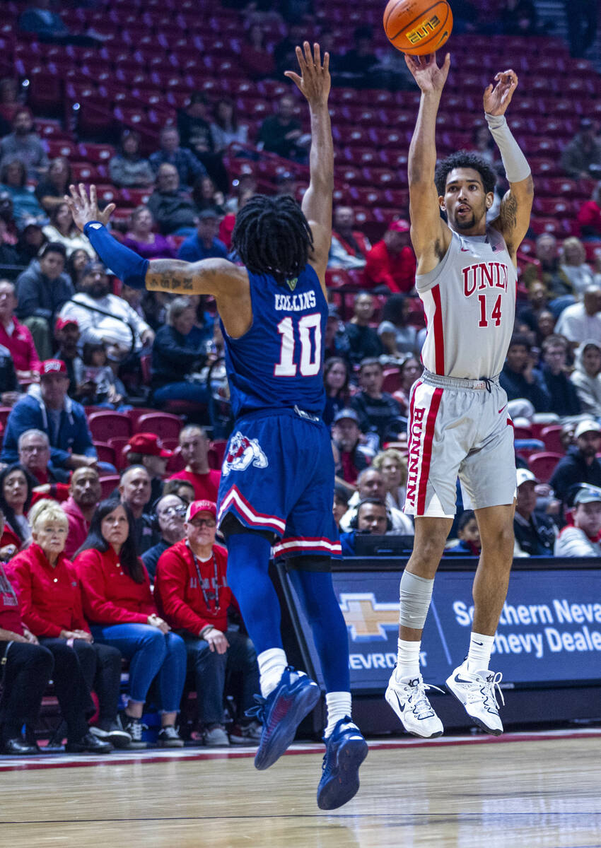 UNLV guard Jailen Bedford (14) gets off a three-point basket over Fresno State Bulldogs guard Z ...