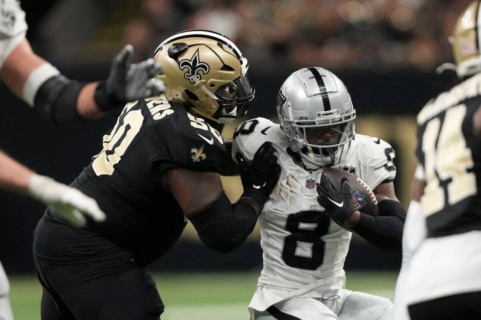 New Orleans Saints defensive tackle Khalen Saunders (50) tackles Las Vegas Raiders running back ...