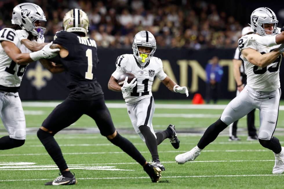 Las Vegas Raiders wide receiver Tre Tucker (11) runs up field during the first half of an NFL f ...