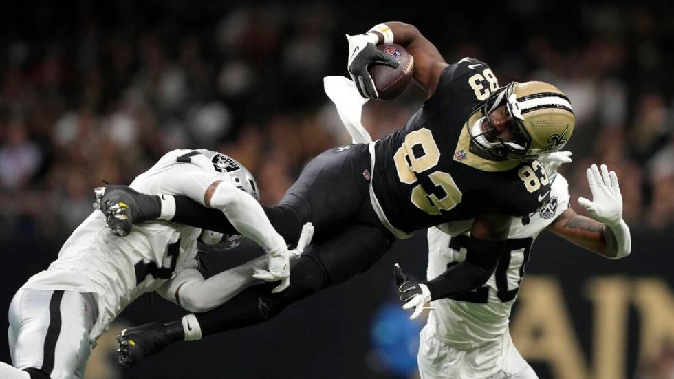 New Orleans Saints tight end Juwan Johnson (83) is tackled by Las Vegas Raiders safety Tre'von ...