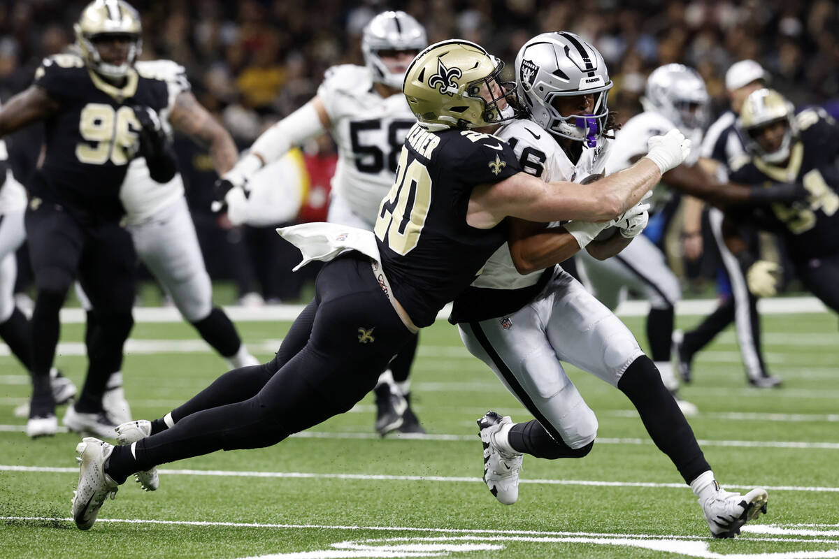 Las Vegas Raiders wide receiver Jakobi Meyers (16) is tackled by New Orleans Saints linebacker ...