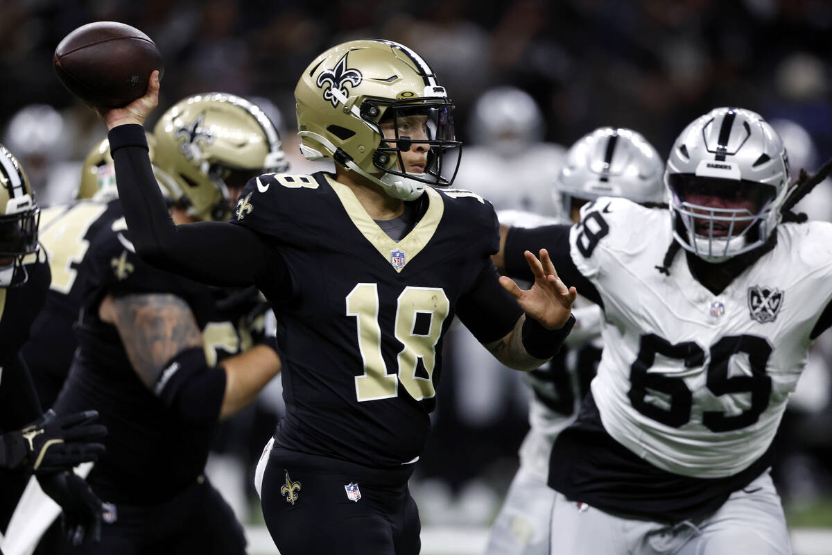 New Orleans Saints quarterback Spencer Rattler (18) throws a pass as he is pressured by Las Veg ...