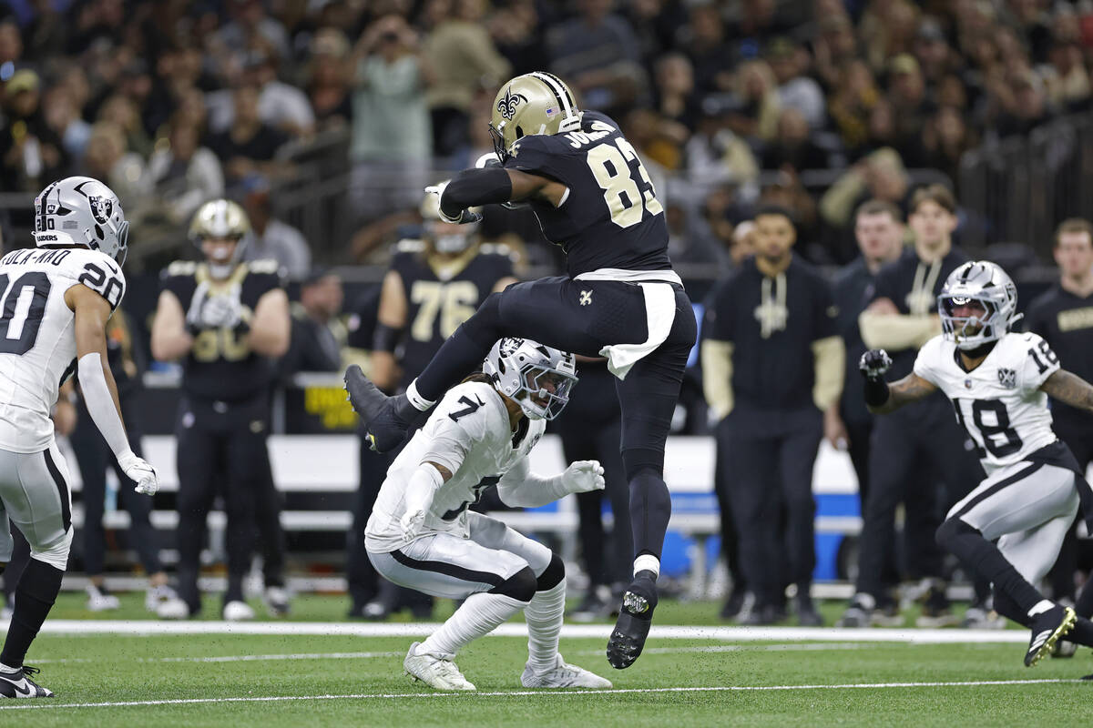 New Orleans Saints tight end Juwan Johnson (83) jumps over Las Vegas Raiders safety Tre'von Moe ...