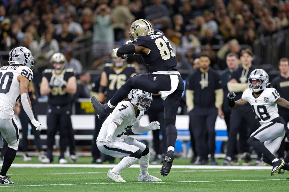 New Orleans Saints tight end Juwan Johnson (83) jumps over Las Vegas Raiders safety Tre'von Moe ...