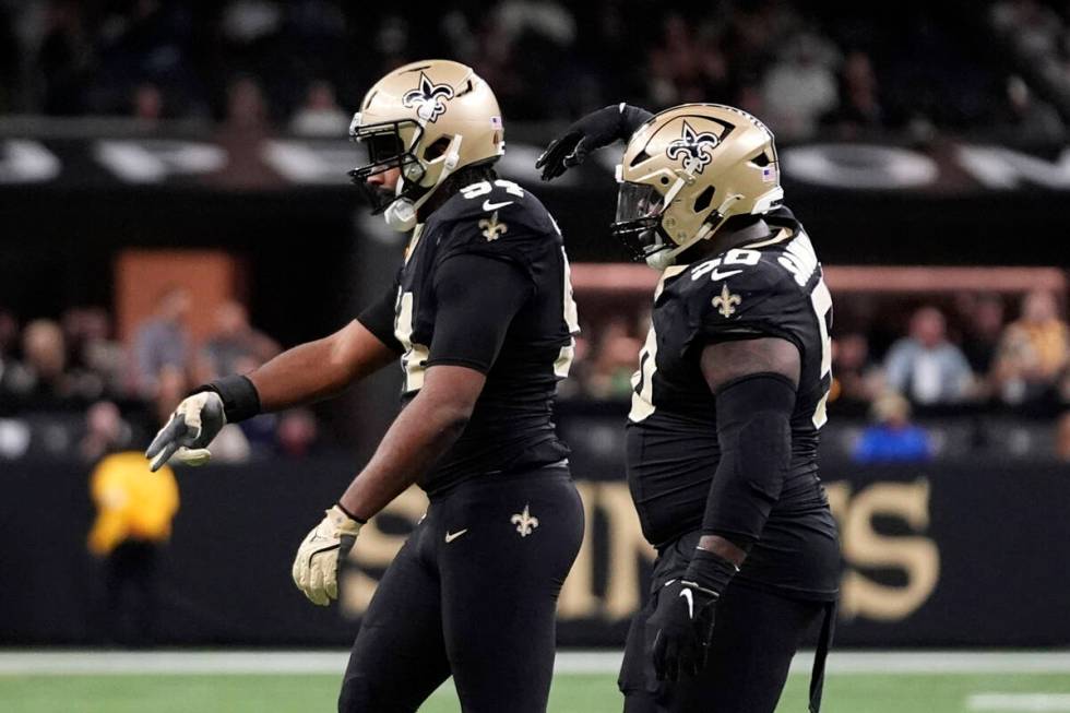 New Orleans Saints defensive end Cameron Jordan, left, reacts after a sack during the first hal ...