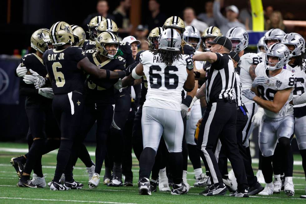 Officials separate players during the first half of an NFL football game between the New Orlean ...