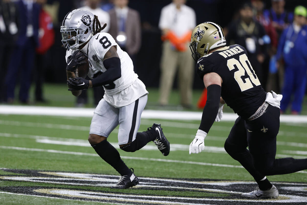 Las Vegas Raiders running back Ameer Abdullah (8) runs from New Orleans Saints linebacker Pete ...