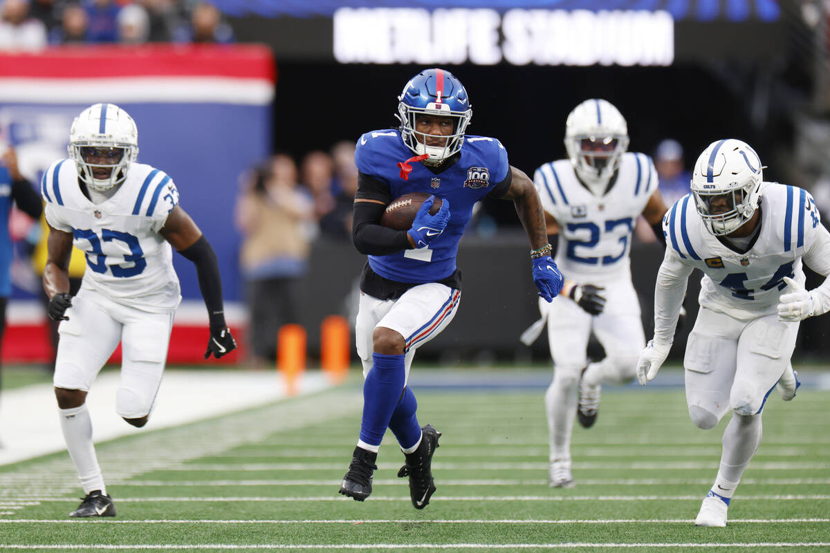 New York Giants wide receiver Malik Nabers (1) scores his second touchdown of the game against ...