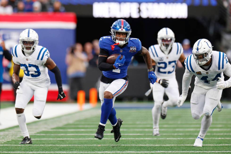 New York Giants wide receiver Malik Nabers (1) scores his second touchdown of the game against ...