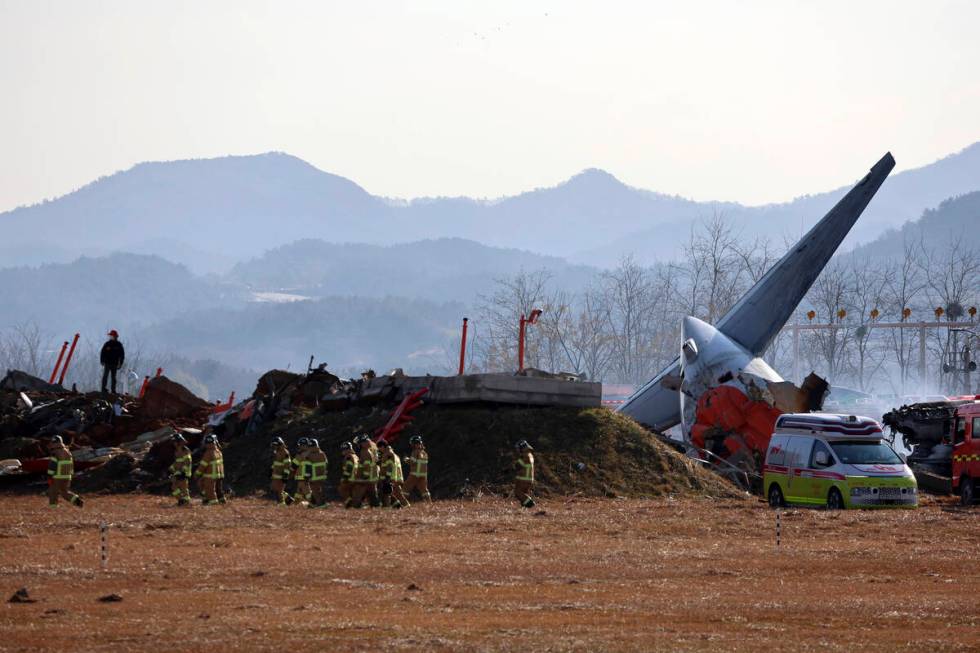 Firefighters and rescue team members work at Muan International Airport in Muan, South Korea, S ...