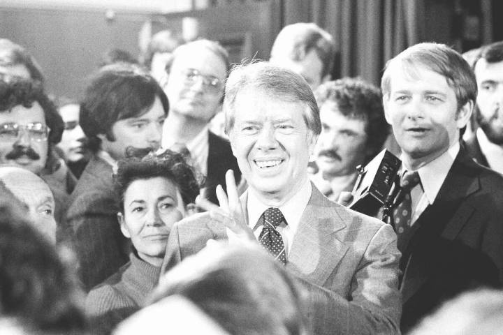 FILE - President Jimmy Carter, center, talks with reporters following his broadcast new confere ...