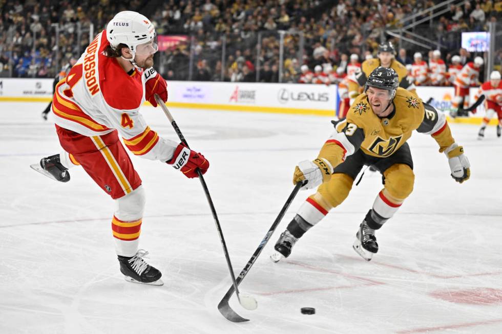 Calgary Flames defenseman Rasmus Andersson (4) and Vegas Golden Knights defenseman Brayden McNa ...