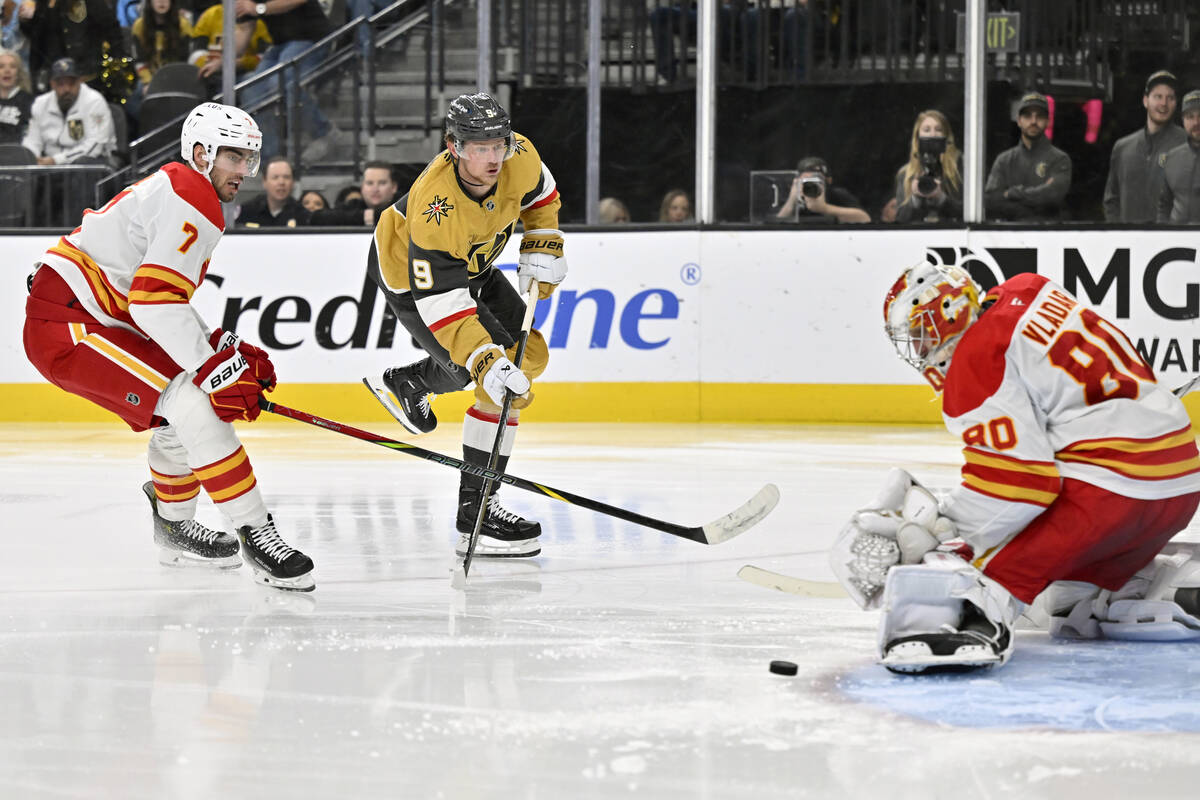 Vegas Golden Knights center Jack Eichel (9) shoots against Calgary Flames defenseman Kevin Bahl ...