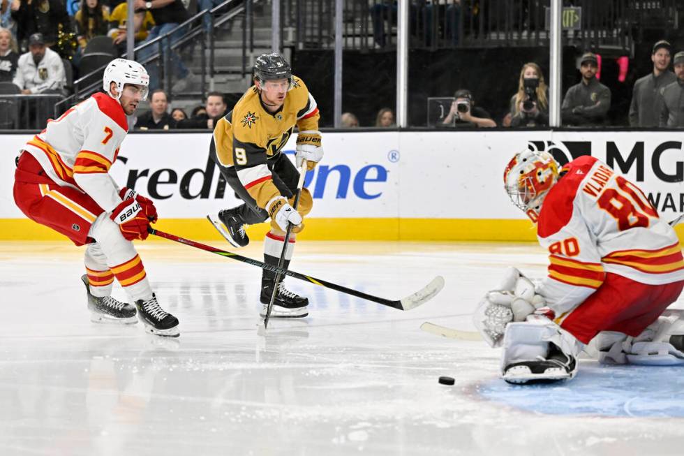 Vegas Golden Knights center Jack Eichel (9) shoots against Calgary Flames defenseman Kevin Bahl ...