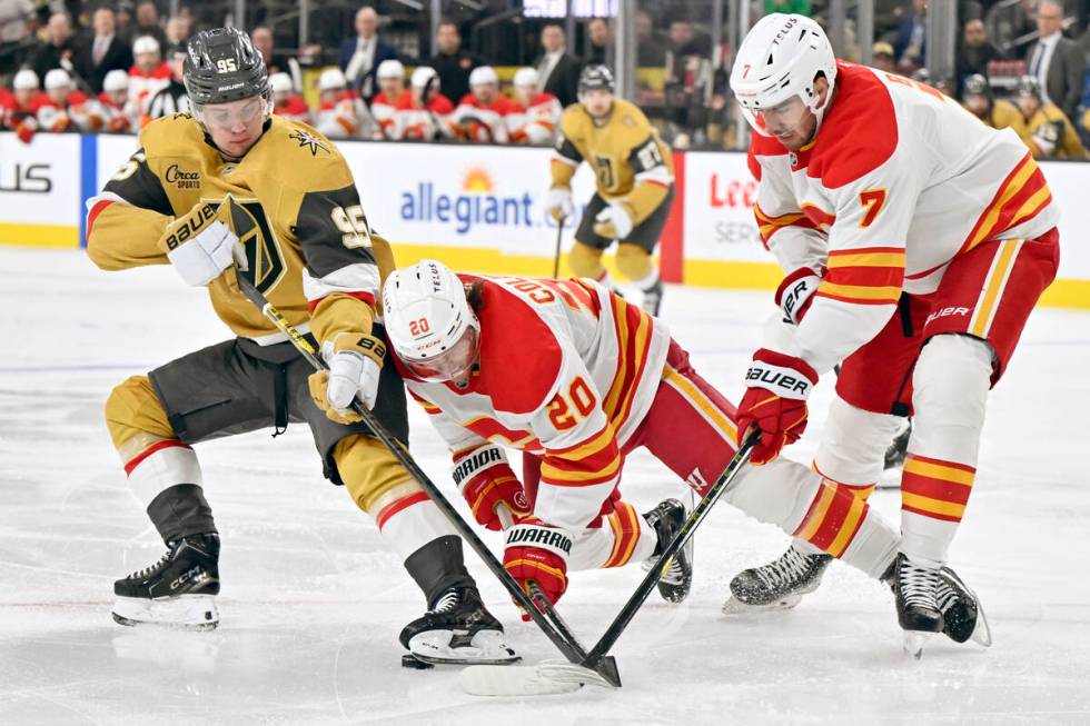 Vegas Golden Knights right wing Victor Olofsson (95) uses his skate to shield the puck from Cal ...