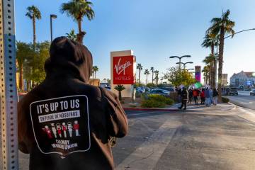 Culinary Local 226 workers on strike on the sidewalk near the main entrance outside the Virgin ...