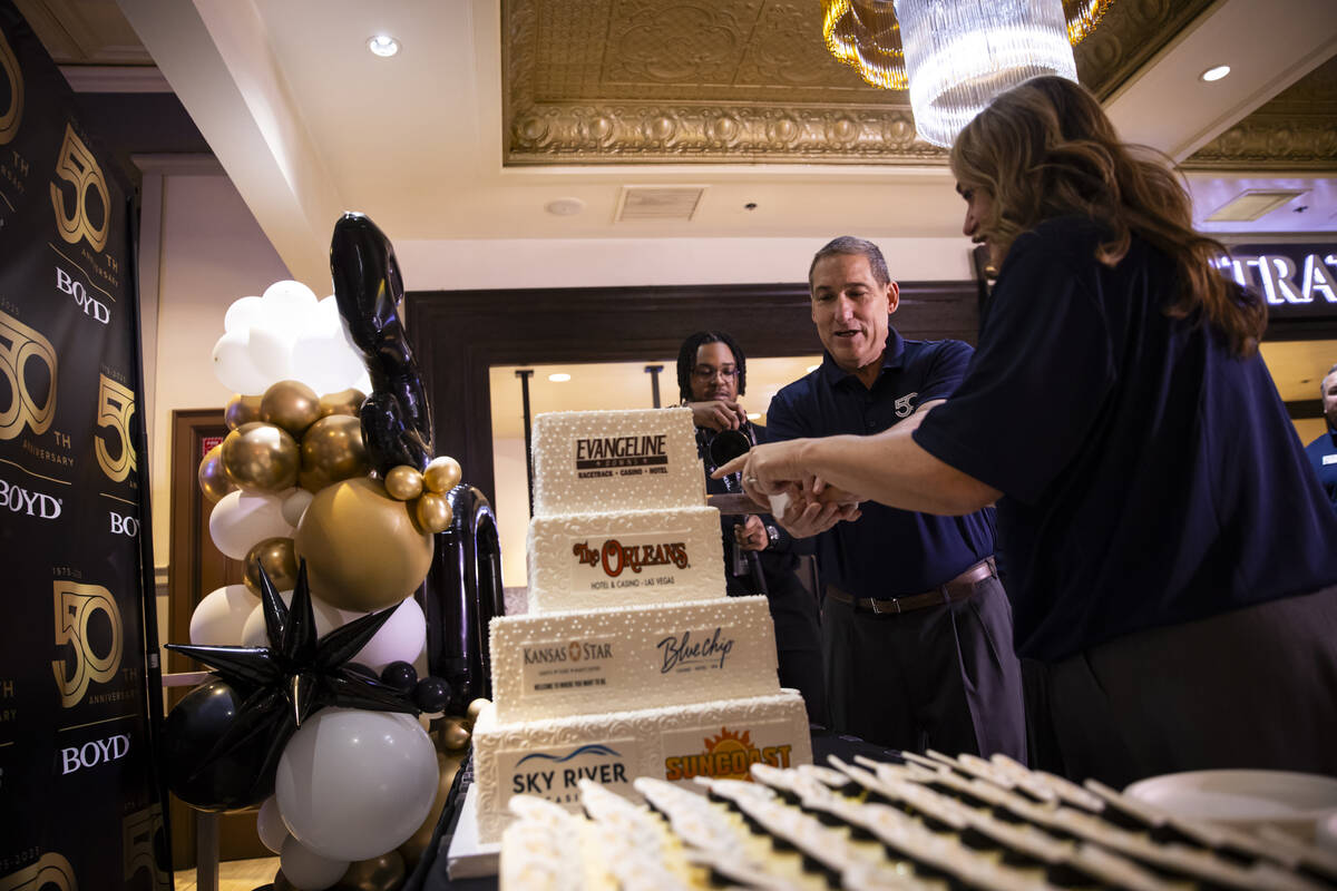 John Sou, general manager of the California Hotel, helps cut the cake during the 50th anniversa ...