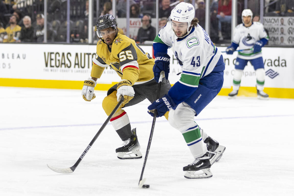 Golden Knights right wing Keegan Kolesar (55) and Vancouver Canucks defenseman Quinn Hughes (43 ...