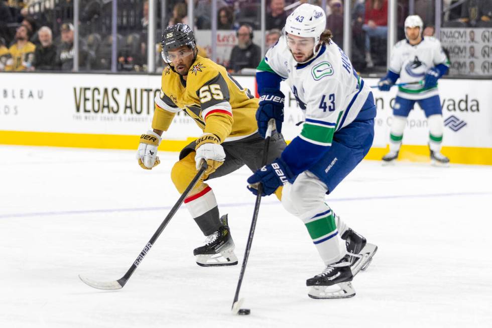 Golden Knights right wing Keegan Kolesar (55) and Vancouver Canucks defenseman Quinn Hughes (43 ...