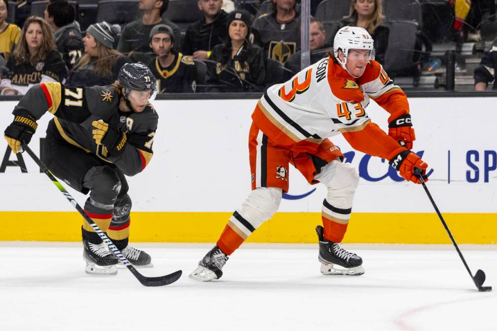 Golden Knights center William Karlsson (71) chases after Anaheim Ducks defenseman Drew Helleson ...