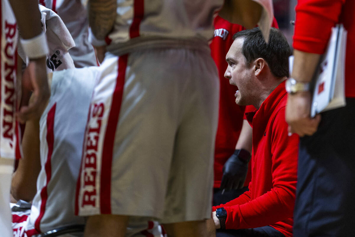 UNLV head coach Kevin Kruger instructs his players on a time out versus the Fresno State Bulldo ...