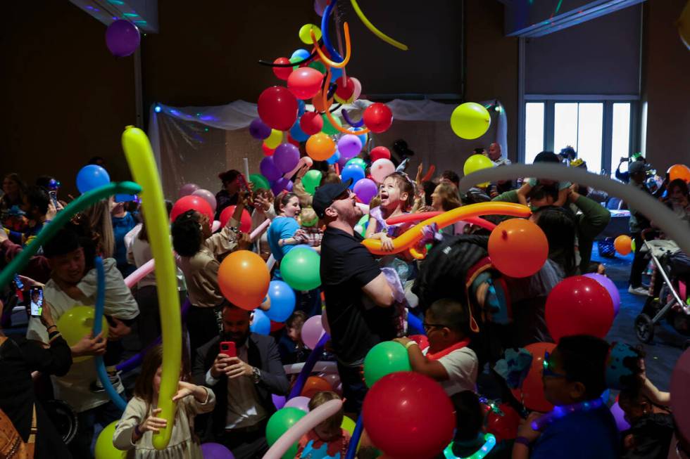 Children and their families celebrate under a balloon drop during “Noon Year’s Ev ...