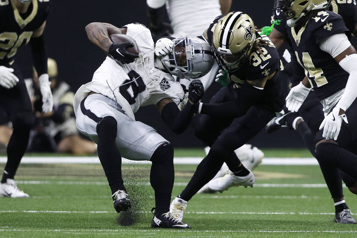 Las Vegas Raiders running back Ameer Abdullah (8) is tackled by New Orleans Saints safety Tyran ...