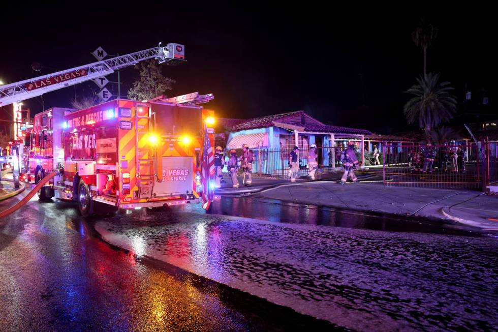 Las Vegas firefighters work a fire at the former Lucky Motel on East Fremont Street in downtown ...