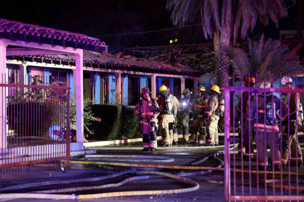 Las Vegas firefighters work a fire at the former Lucky Motel on East Fremont Street in downtown ...