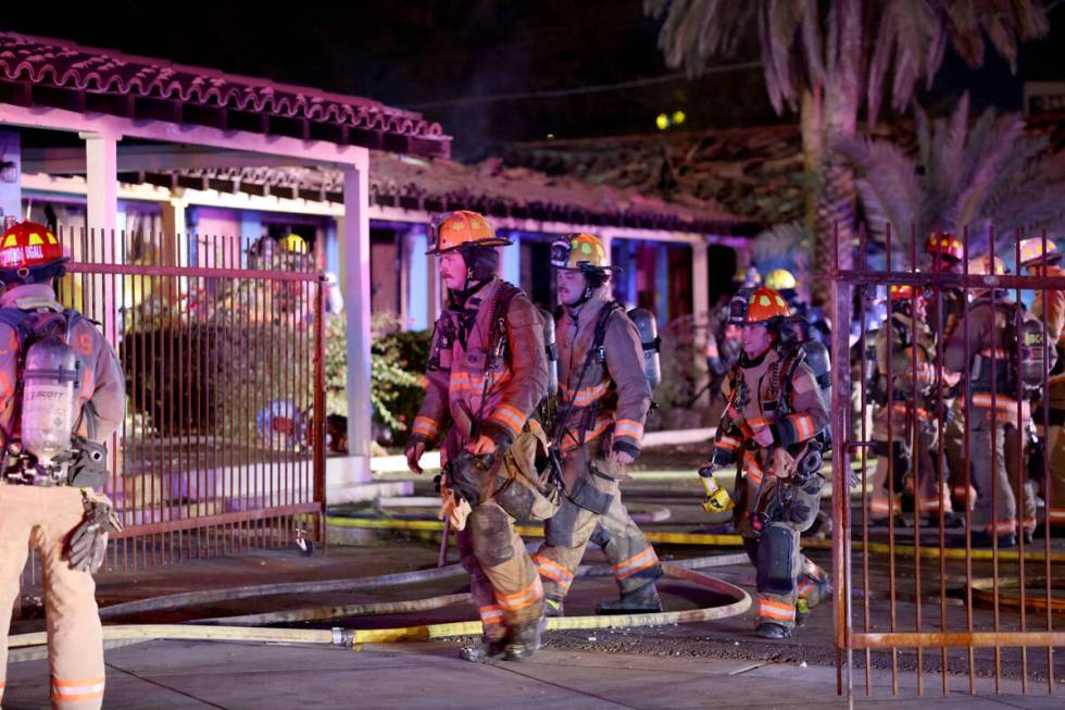 Las Vegas firefighters work a fire at the former Lucky Motel on East Fremont Street in downtown ...