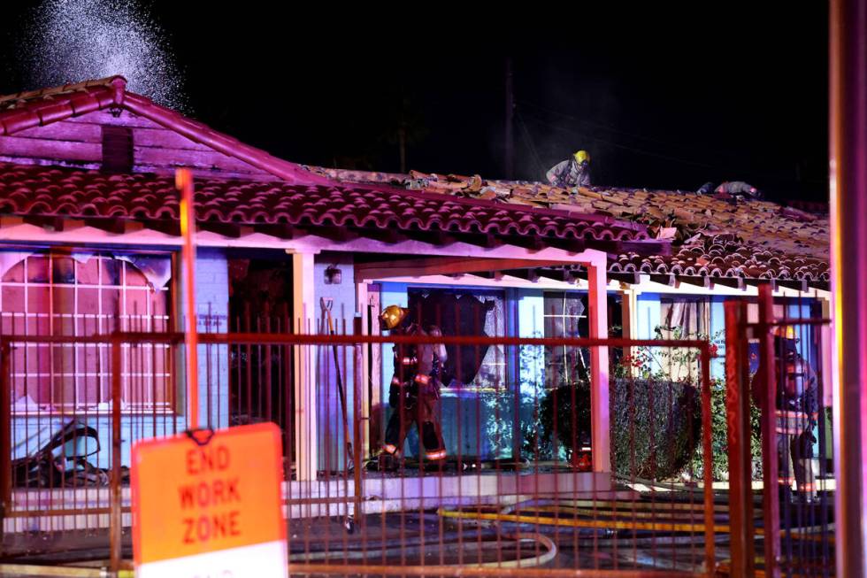 Las Vegas firefighters work a fire at the former Lucky Motel on East Fremont Street in downtown ...