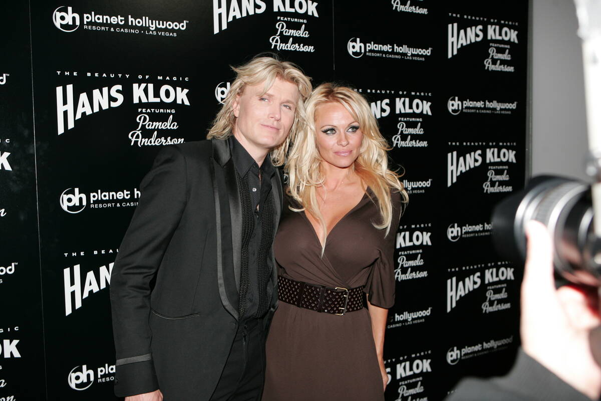 Magician Hans Klok arrives with his featured star Pamela Anderson, who is wearing Vintage Halst ...