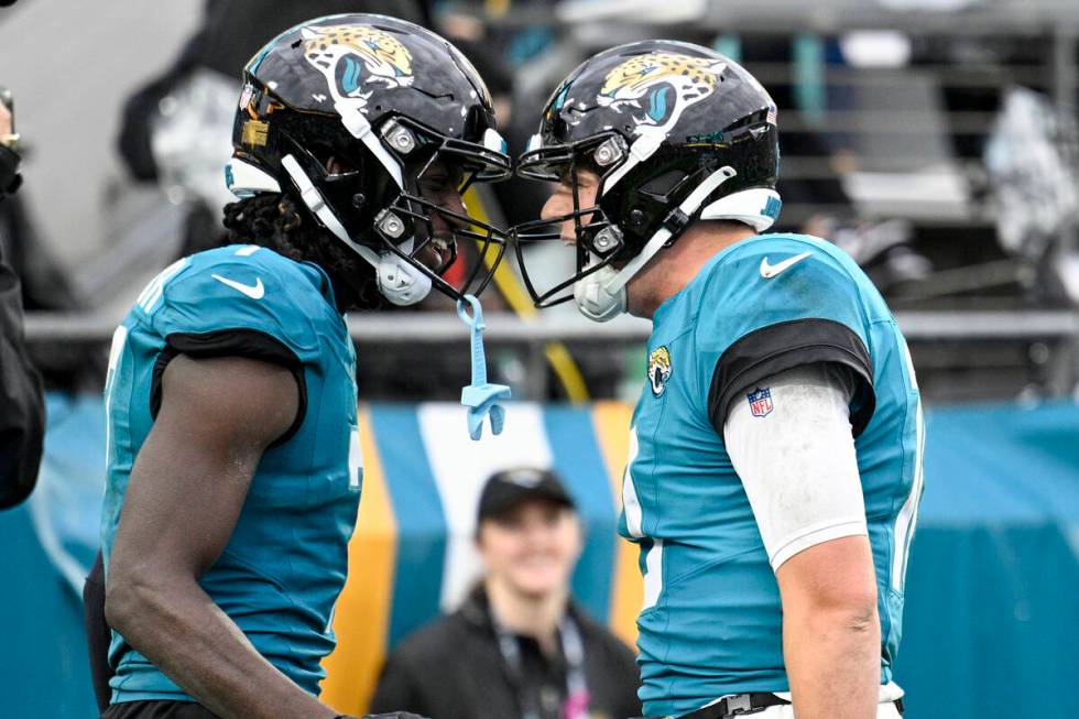 Jacksonville Jaguars wide receiver Brian Thomas Jr., left, and Jacksonville Jaguars quarterback ...