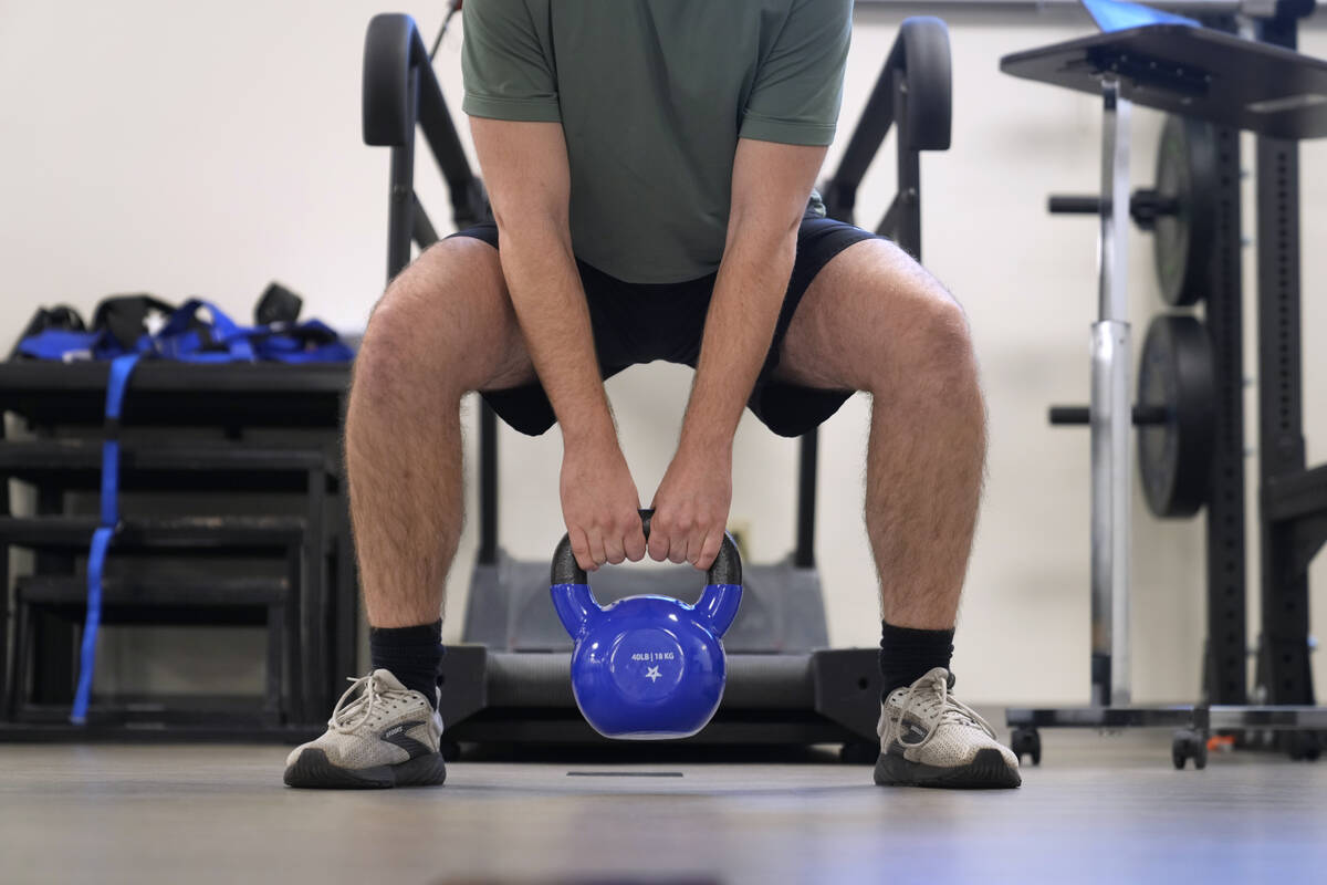 Jacob Bullard lifts a weight as part of his physical therapy at WashU, Monday, Dec. 16, 2024, i ...