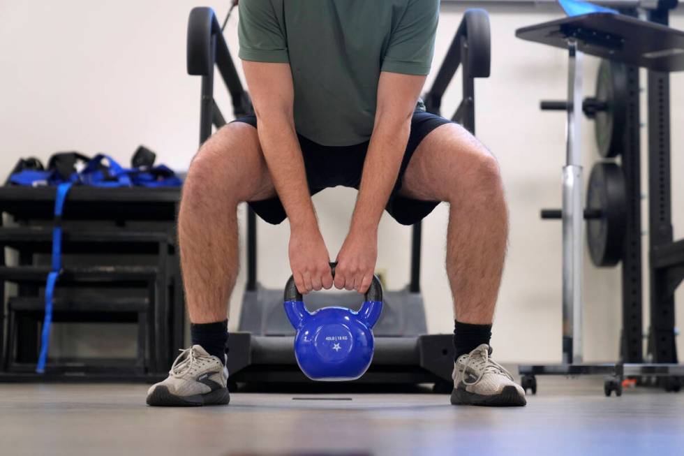 Jacob Bullard lifts a weight as part of his physical therapy at WashU, Monday, Dec. 16, 2024, i ...