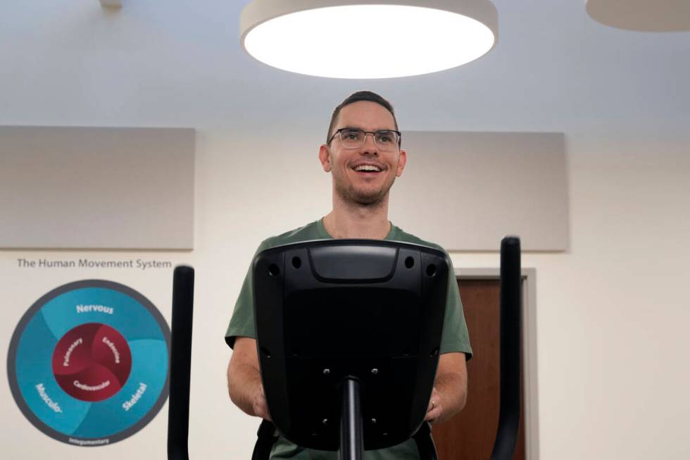 Jacob Bullard warms up on an elliptical machine while undergoing physical therapy at WashU, Mon ...