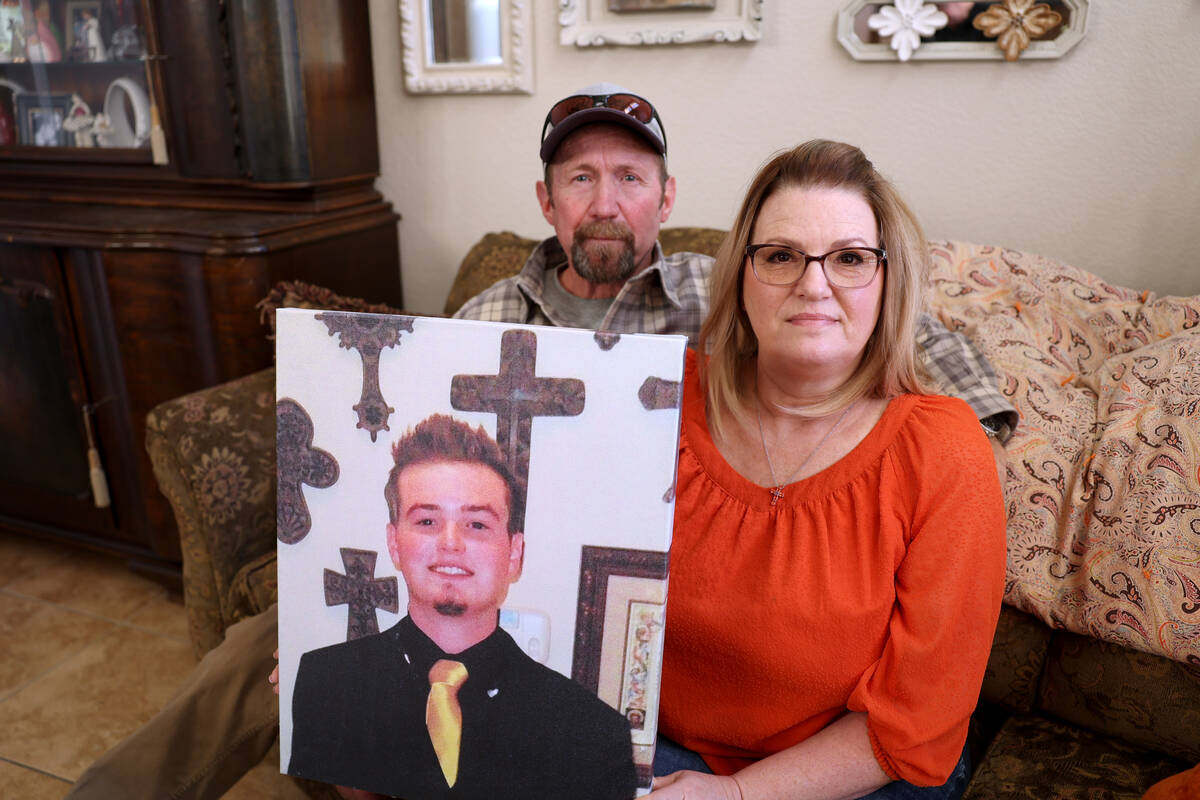 The parents Chris Ruby, Jeff and Sherry Ruby, pose with his picture at their Las Vegas home Tue ...